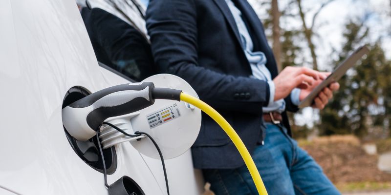 A homeowner installs a personalized electric car charger in his garage.