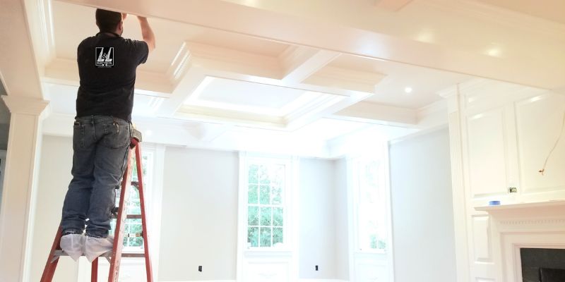 electrician working on installing lighhting system in a new house