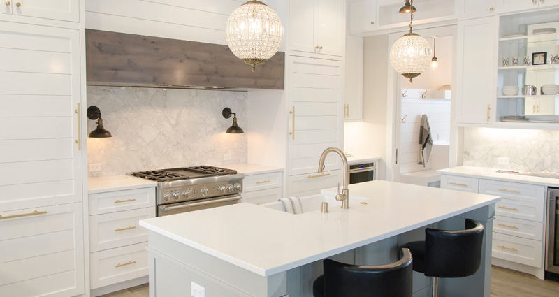 a modern kitchen with a counter and nice lightings